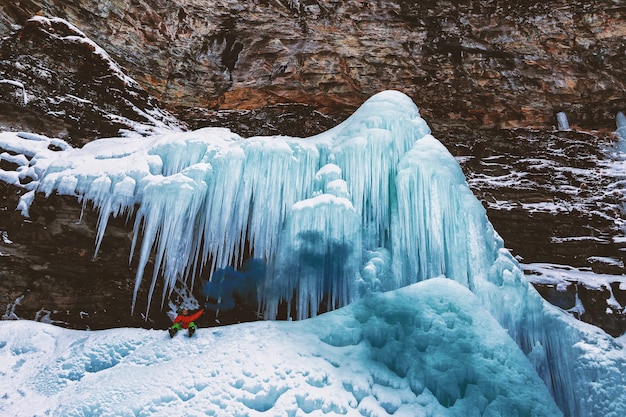 Person Sits on Mountain With Icicles
