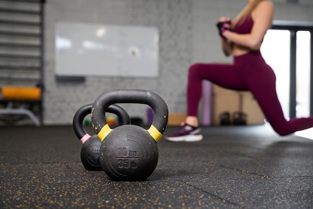 Person in sport gym using kettlebells