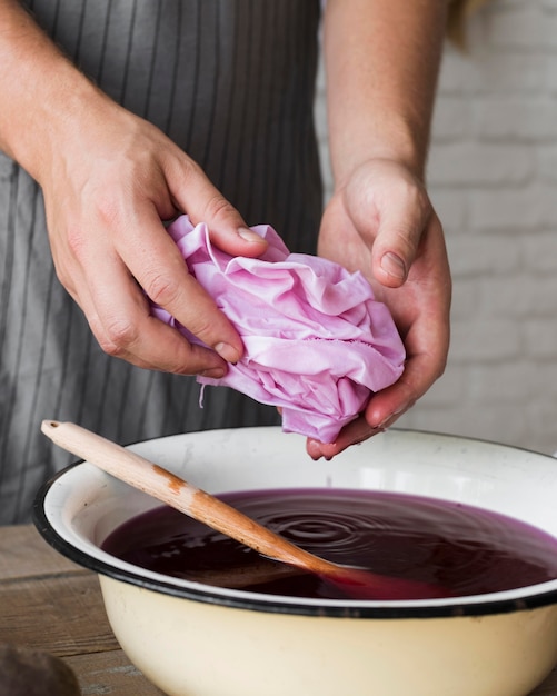 Free photo person squeezing cloth from natural dye close up