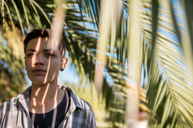 Person standing in shadow of palm branches