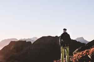 Free photo person standing on top of the mountain