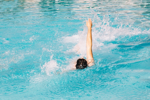 Free photo person swimming backstroke