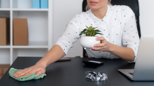 Free photo person taking care of office cleaning