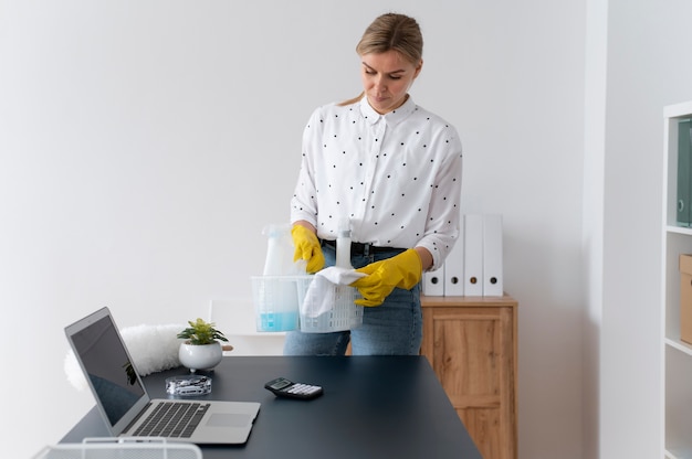 Free photo person taking care of office cleaning