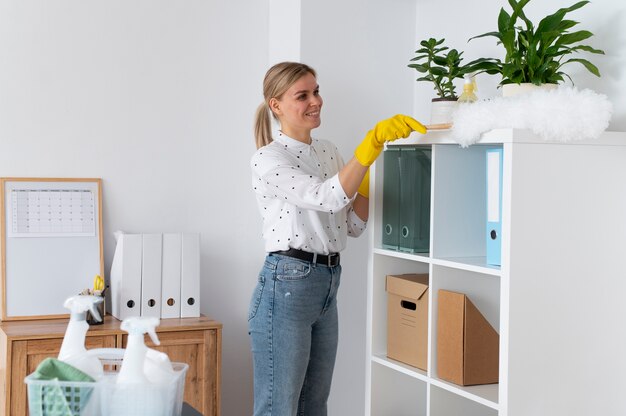 Free photo person taking care of office cleaning