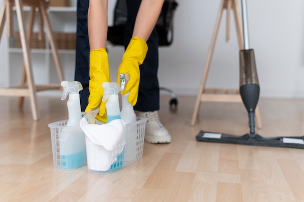 Free photo person taking care of office cleaning