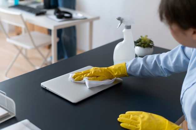 Free photo person taking care of office cleaning