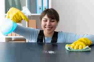 Free photo person taking care of office cleaning