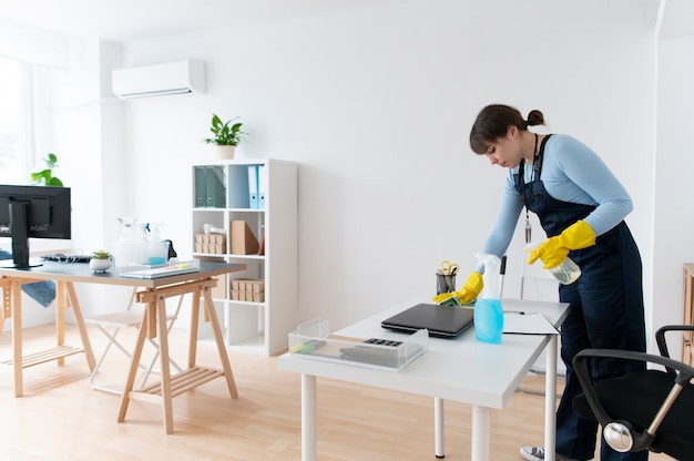 Free photo person taking care of office cleaning