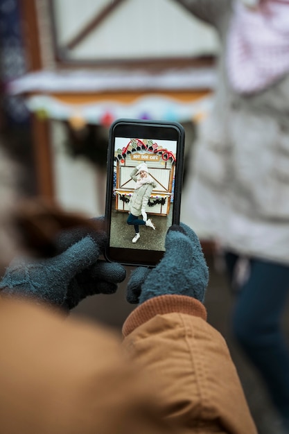 Person taking a photo of a woman outdoors