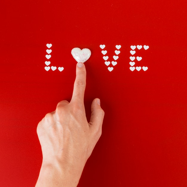 Free photo person touching heart in love inscription