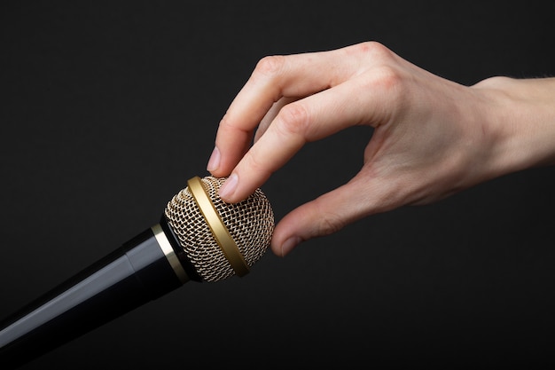 Free photo person touching microphone for asmr