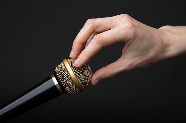 Person touching microphone for asmr