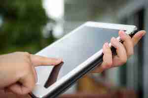 Free photo person touching a tablet