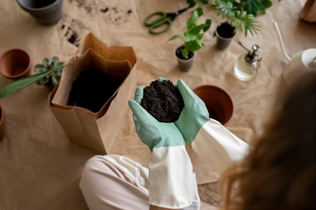 Person transplanting plants in new pots