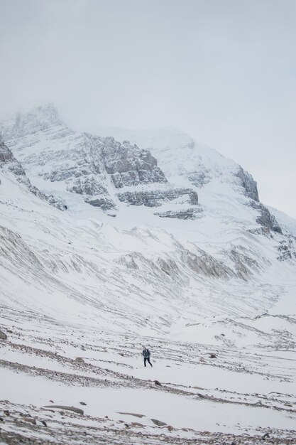 Person trekking on icy mountain