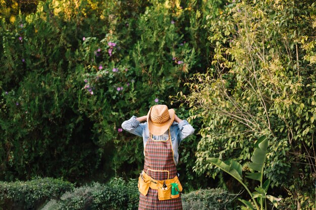 Person tying apron in garden