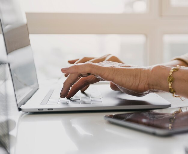 Person typing on laptop keyboard