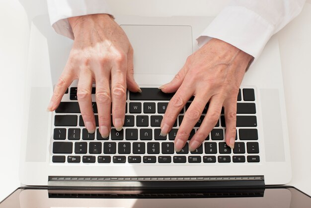 Person typing on laptop top view