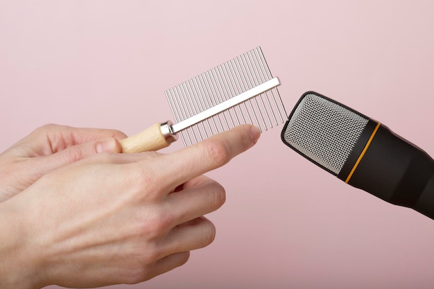 Person using comb close to microphone for asmr