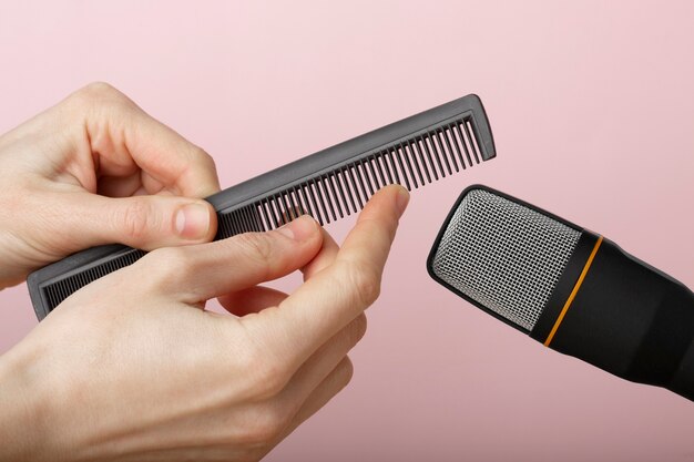 Person using comb close to microphone for asmr