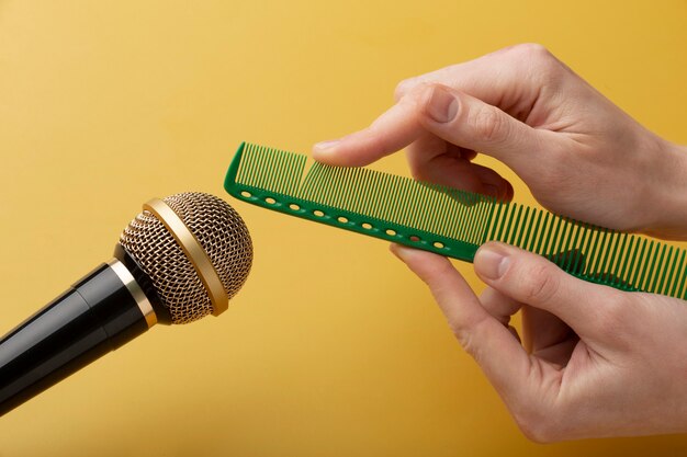 Person using comb close to microphone for asmr