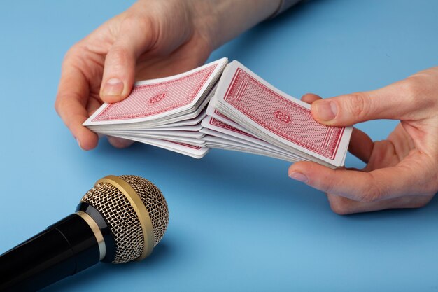 Person using deck of playing cards close to microphone for asmr