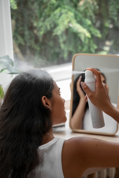 Person using dry shampoo