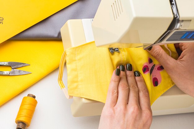 Person using machine to sew face masks