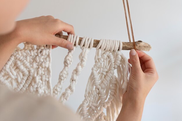 Person using the macrame technique indoors