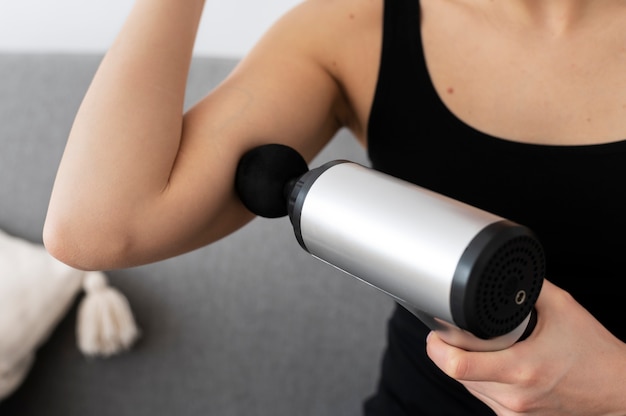 Free photo person using massage gun