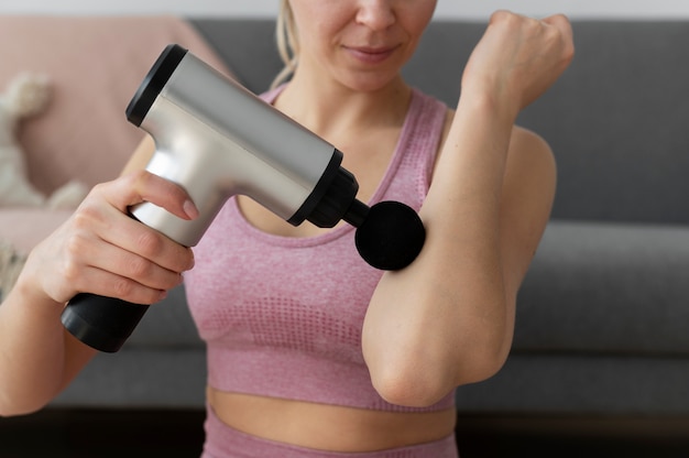 Free photo person using massage gun