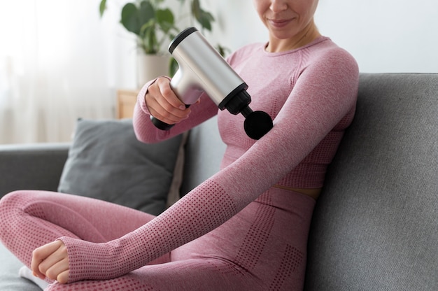 Free photo person using massage gun