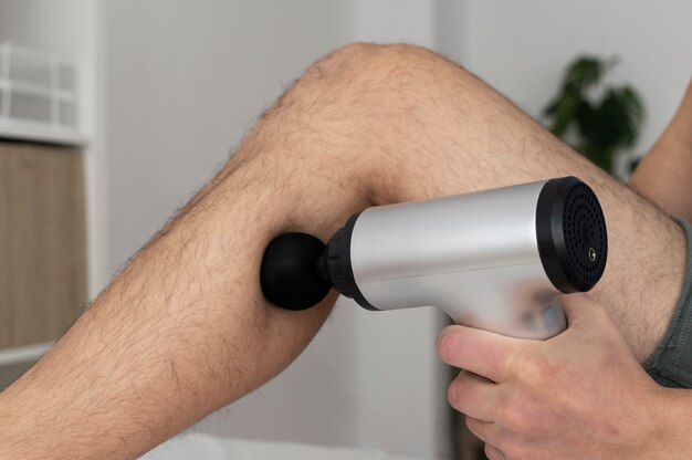 person using massage gun