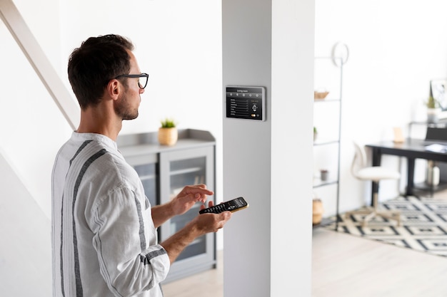 Person using a smartphone in his automated home