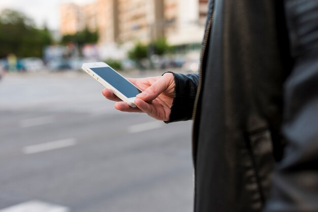 Person using smartphone on street