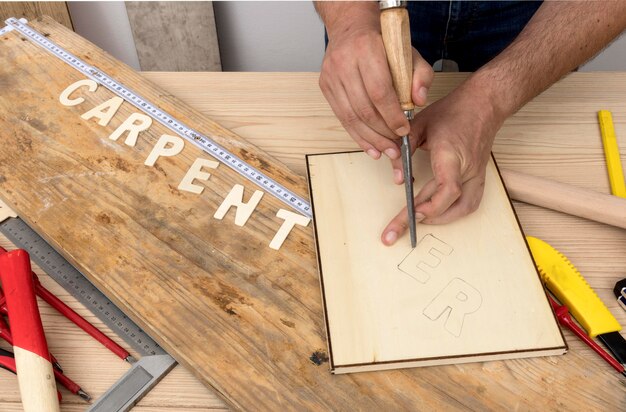 Person using tools to create carpentry word high view