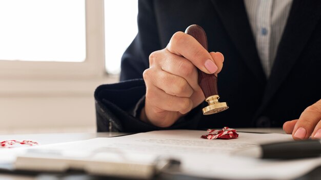 Person using a wax seal on a certificate