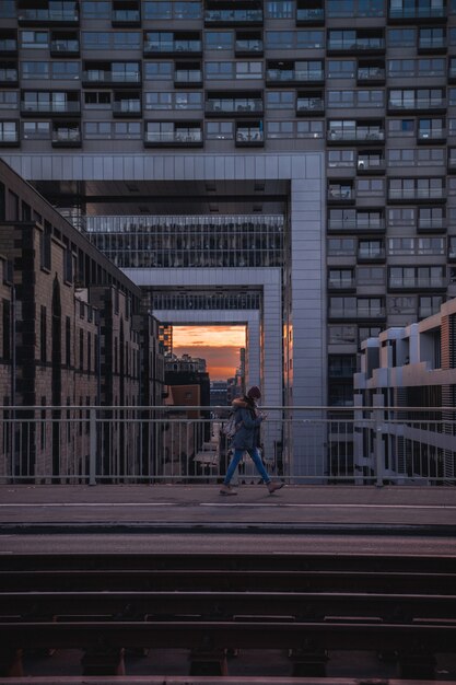 Person walking on bridge at sunset