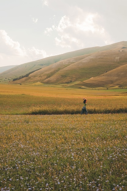 Free photo person walking on green and brown field