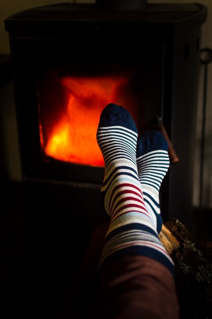 Person warming up feet next to the fire