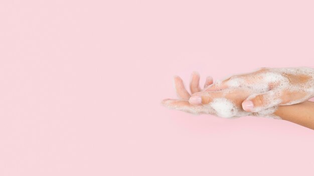 Person washing hands with soap