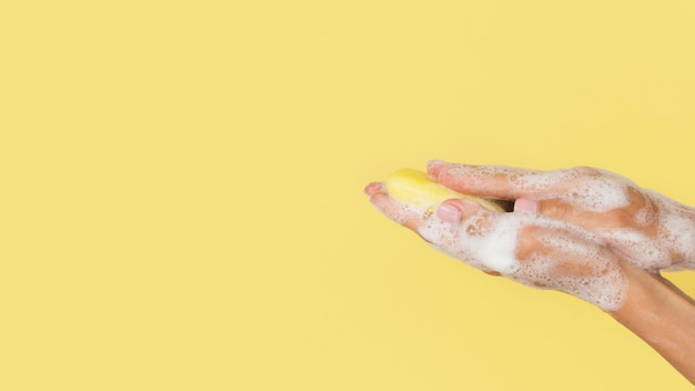 Person washing hands with soap