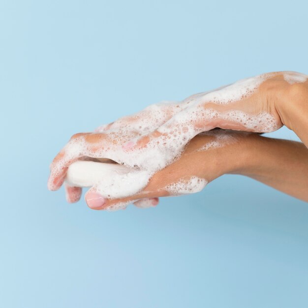 Person washing hands with soap