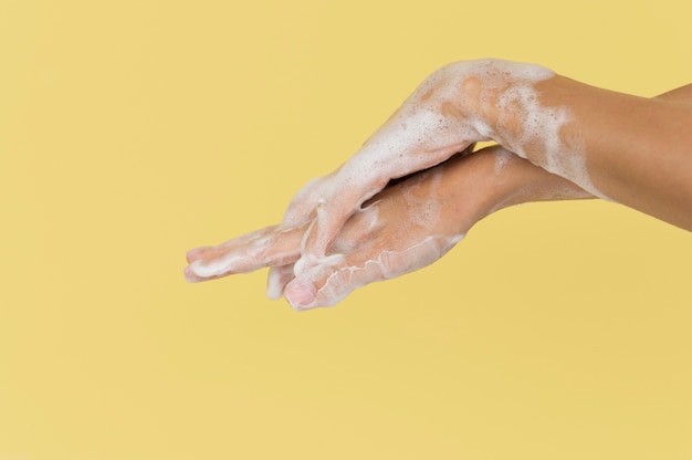 Person washing hands with soap