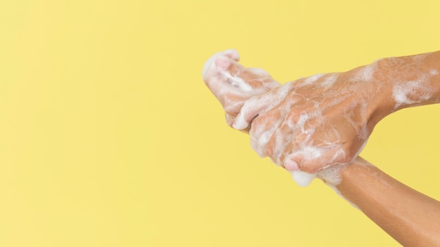 Person washing hands with soap