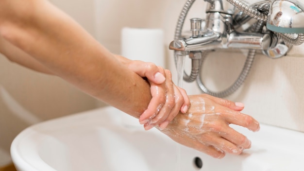 Person washing hands with soap