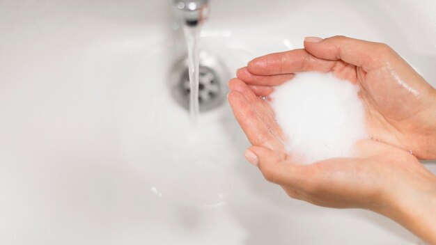 Person washing hands with soap