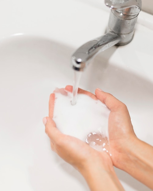 Person washing hands with soap