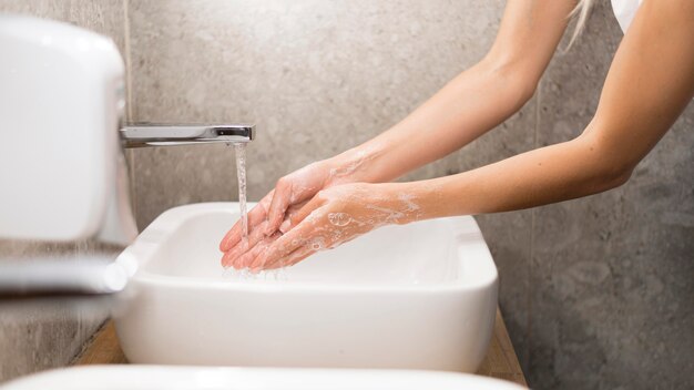 Person washing hands with soap